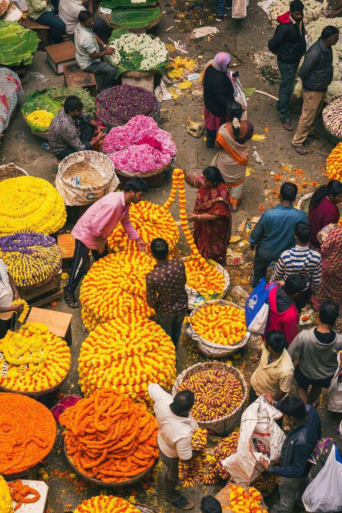 Overhead view of a busy flower market with heaps of marigolds