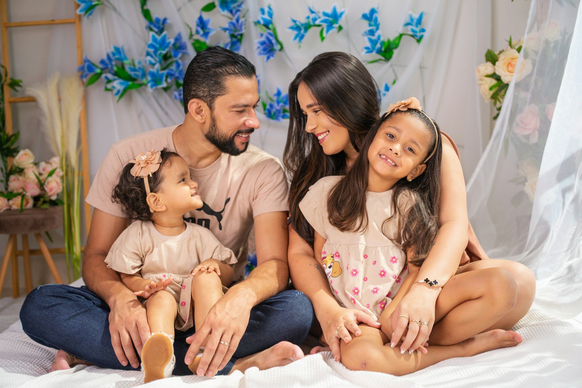 Happy young family of four smiling together