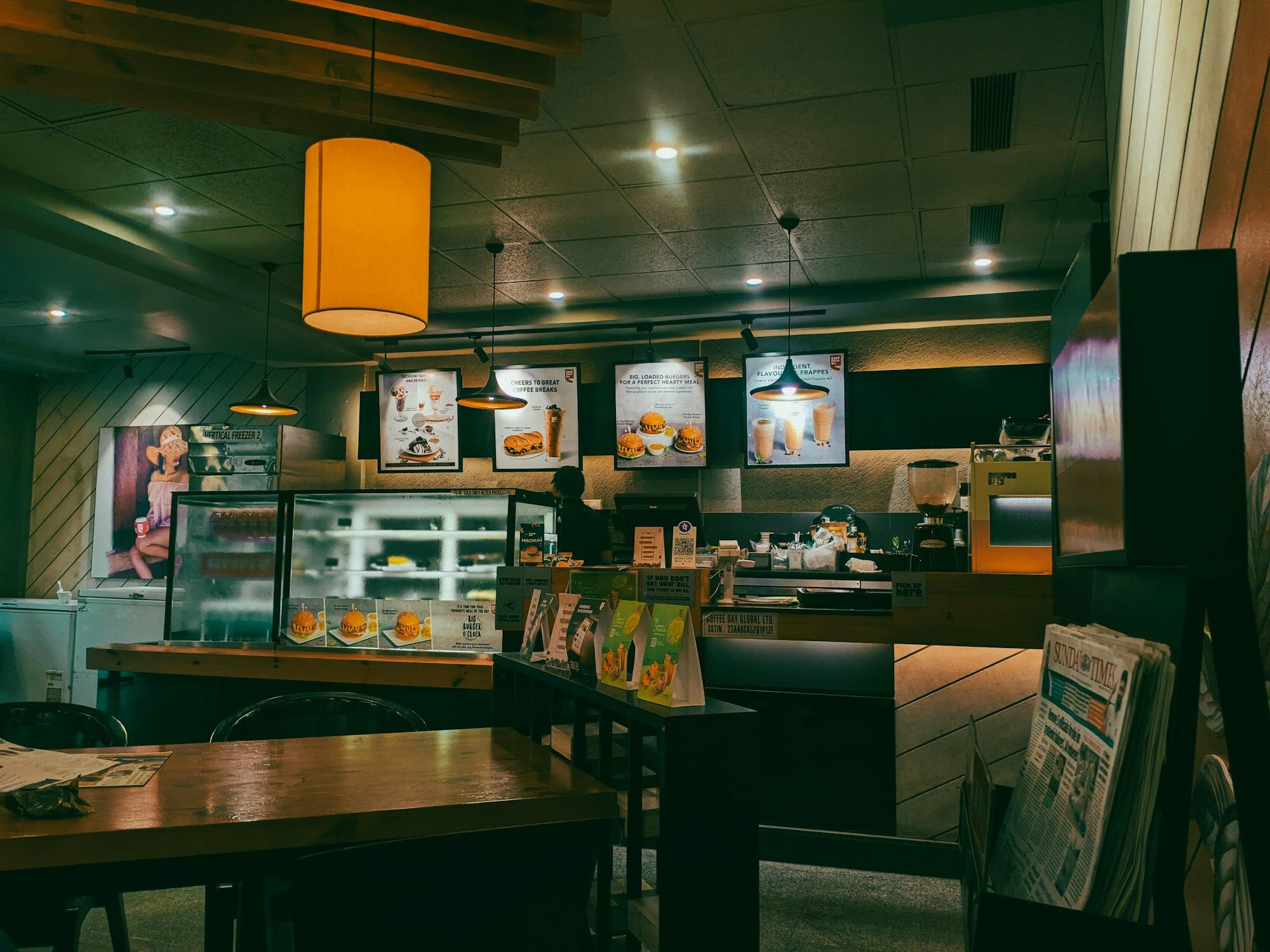 Warm café interior with pendant lights over a wooden counter