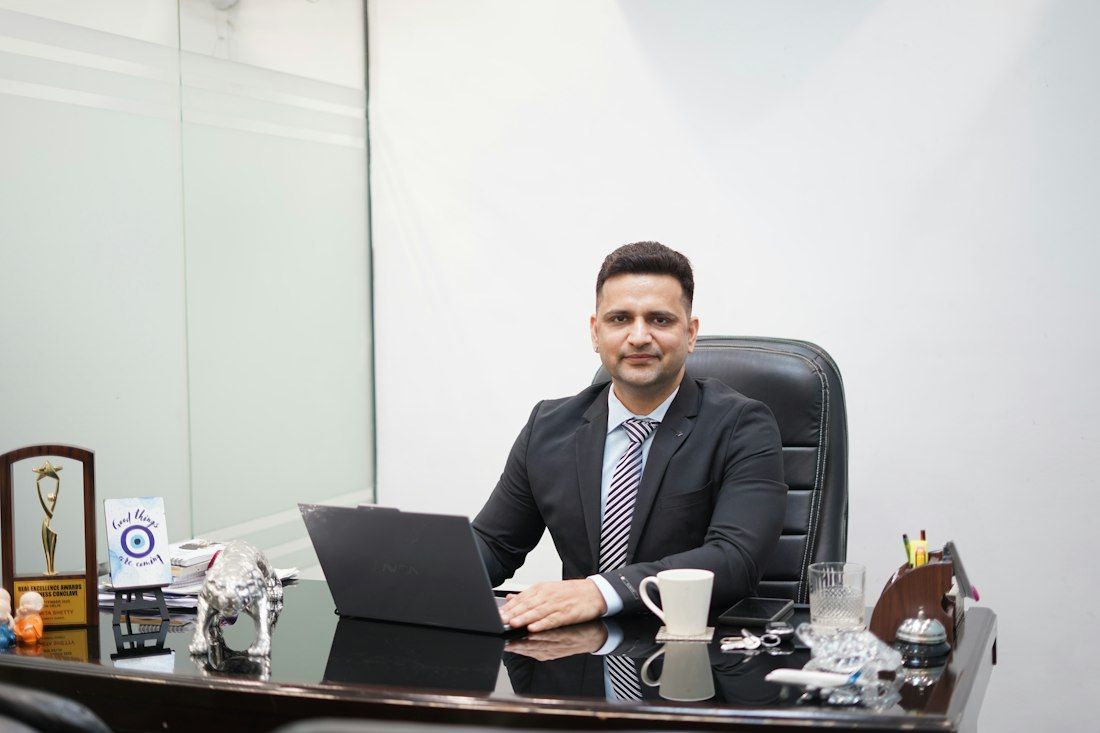 A professional in a suit working at his desk