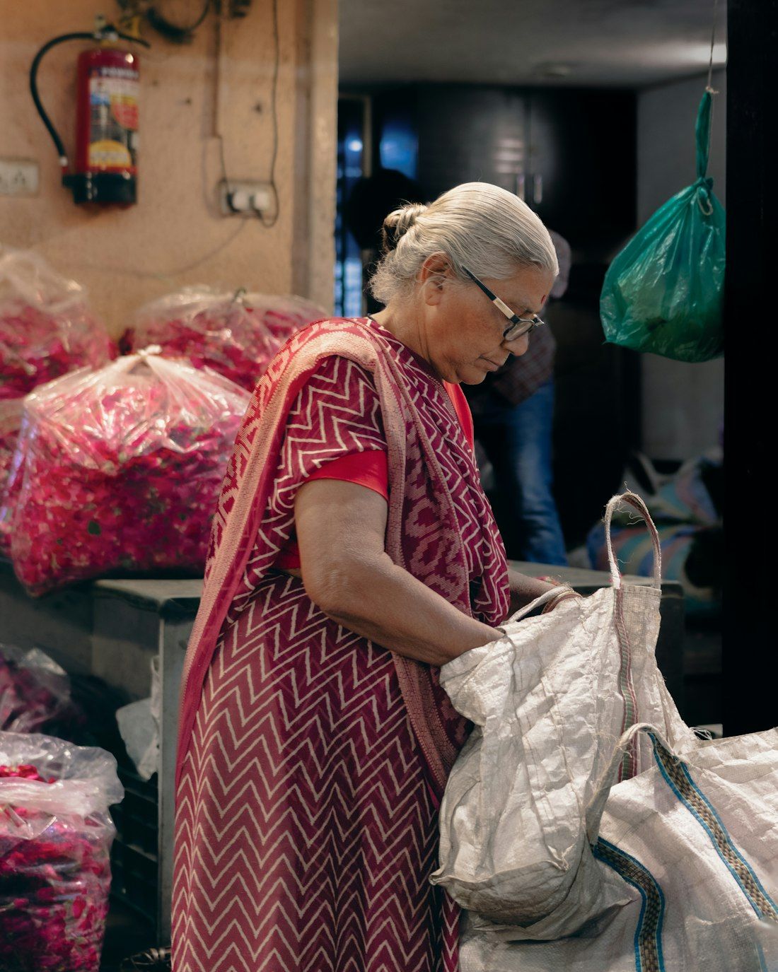 Woman choosing fresh flowers at a market stall