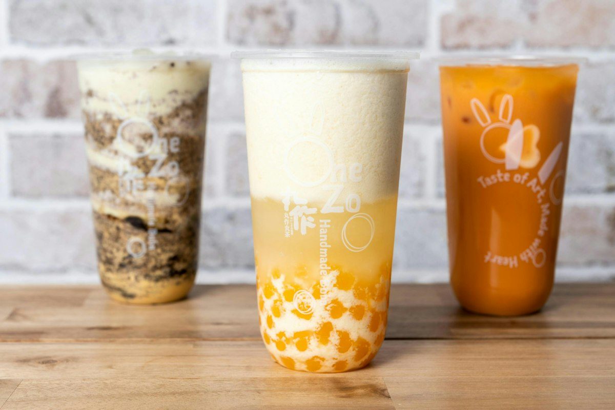 Three bubble tea cups lined up on a counter