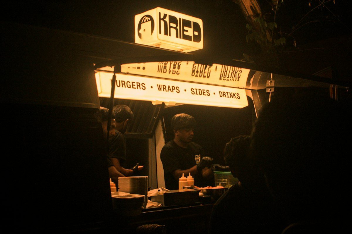 Glowing food truck sign at night