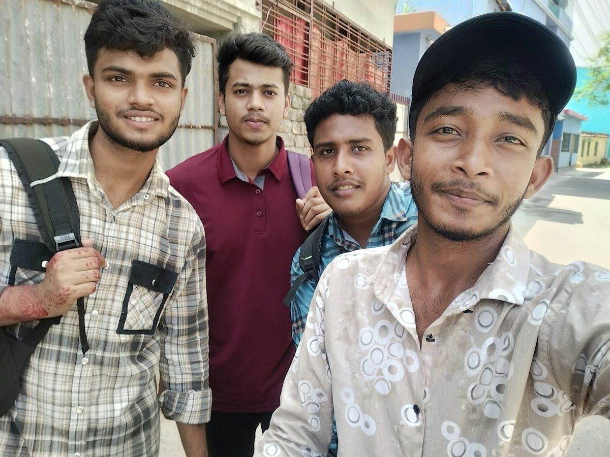 Four young friends taking a selfie on a street