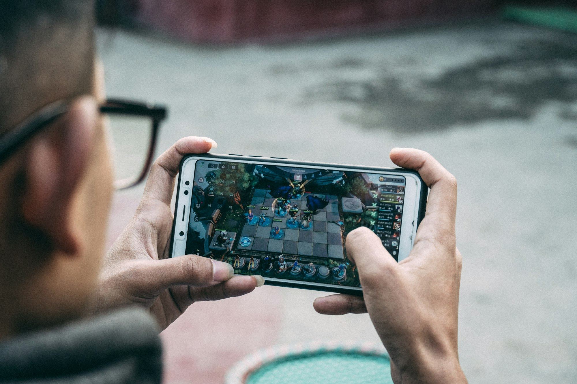 Hands playing a mobile game