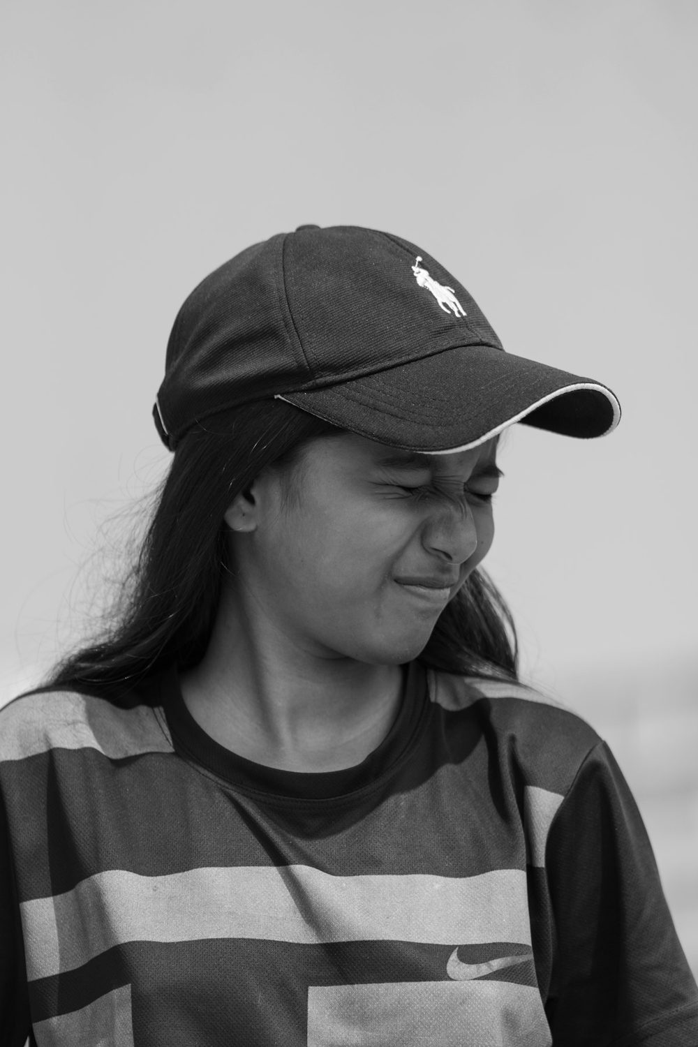 Young woman in a cap smiling, in black and white