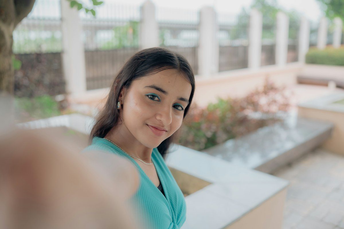 Young woman smiling at her phone camera
