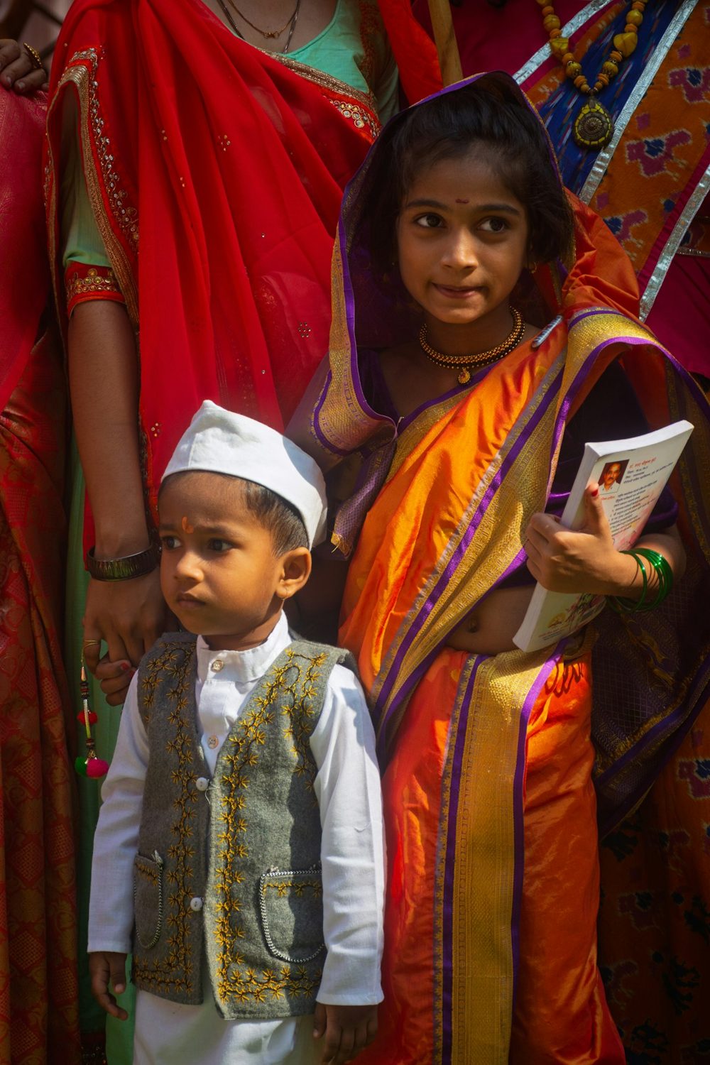 Two children in traditional attire smiling