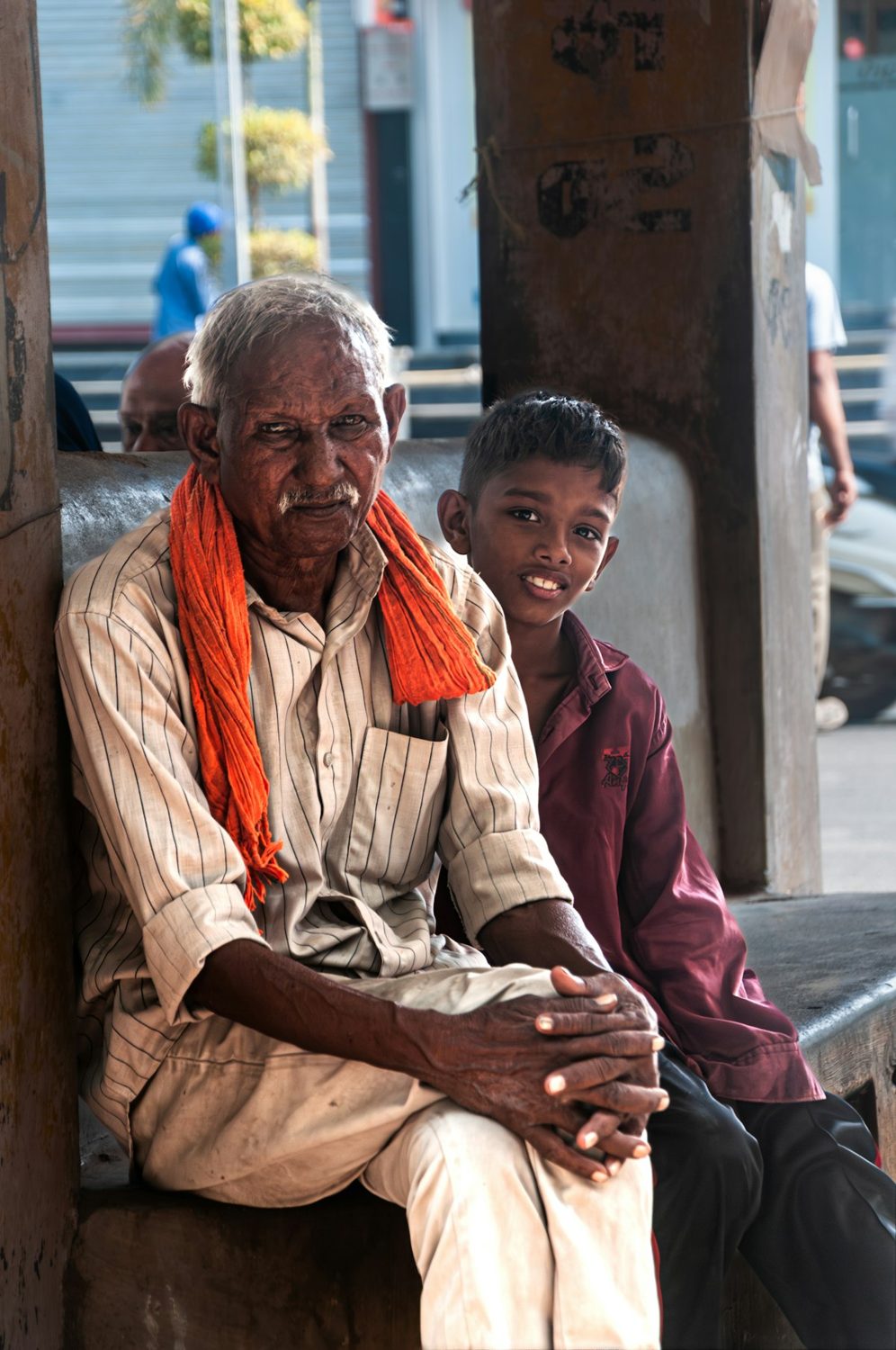 Elderly man sitting with a young boy